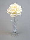 Leafless ivory crepe paper rose standing in a slender glass vase